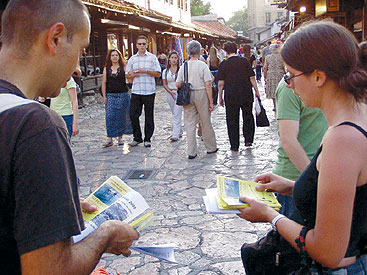 a group of people looking at a cell phone