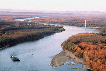 a large body of water with a mountain in the background