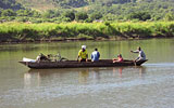 a group of people in a small boat in a body of water