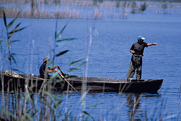 a group of people in a boat on a body of water