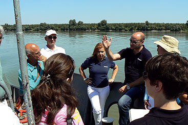 a group of people standing next to a body of water