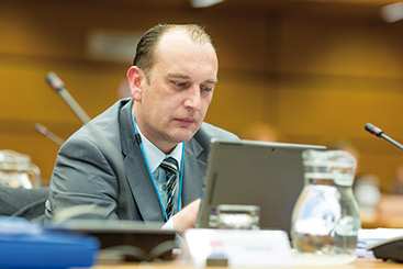 a man sitting at a table using a laptop