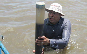 a person standing next to a body of water