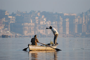 a person riding on the back of a boat in the water