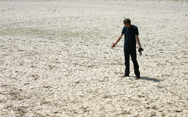 a man throwing a frisbee at a beach