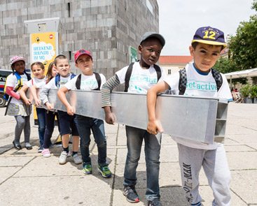 a group of people standing on a sidewalk