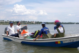 a group of people in a small boat in a body of water