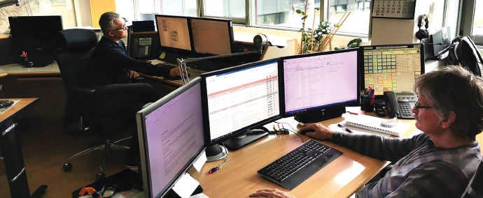 a man sitting at a desk in front of a laptop computer