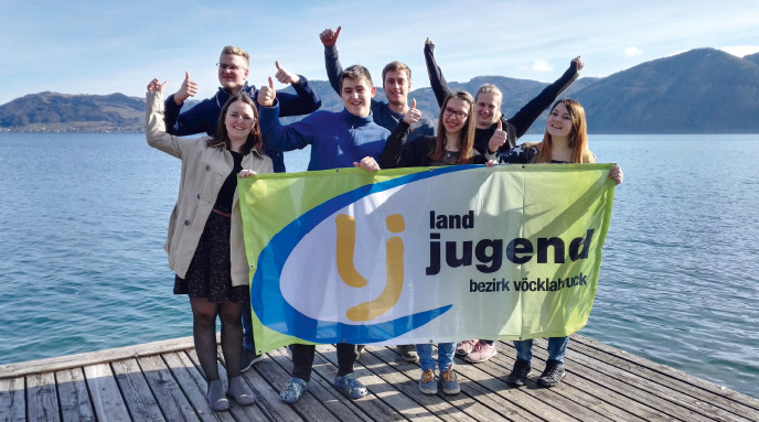 a group of people standing next to a body of water