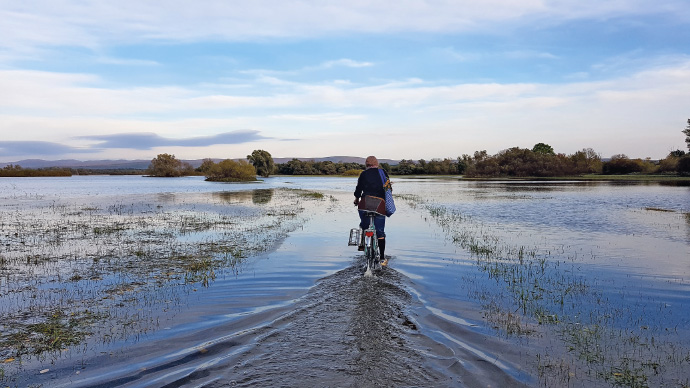 a man standing next to a body of water