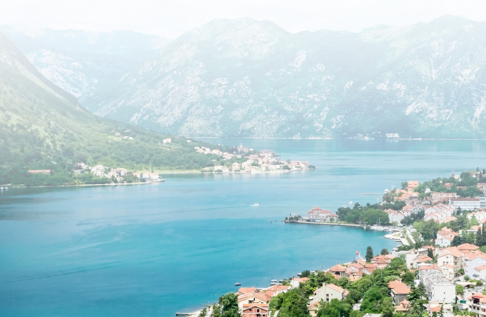 a large body of water with a mountain in the background