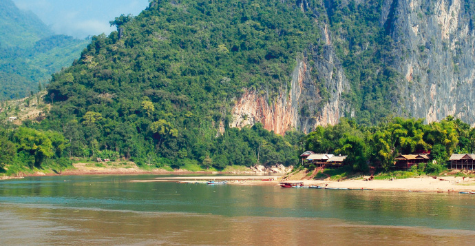 a body of water with a mountain in the background