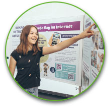 a person holding a sign posing for the camera