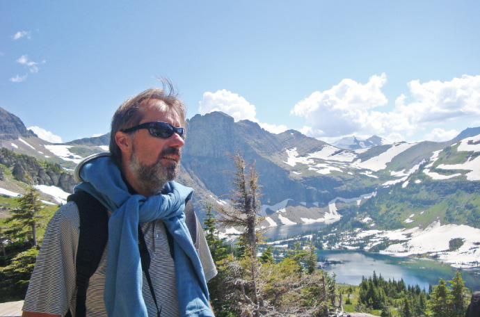 a man standing in front of a mountain