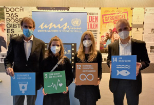 a group of people standing in front of a sign