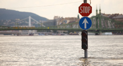 a sign and traffic light showing out of a river