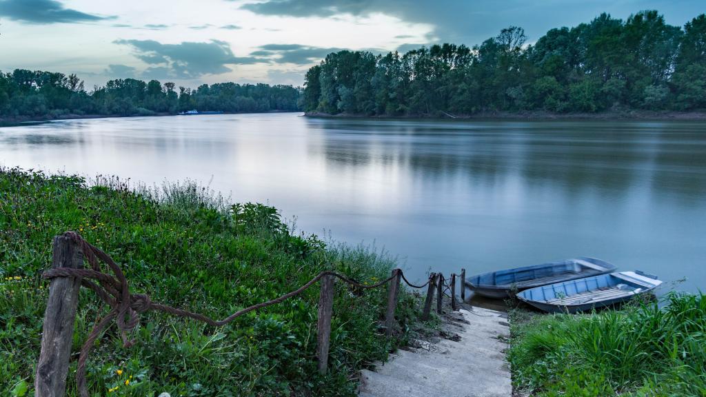 View of the Sava River with a small boat at the riverbank