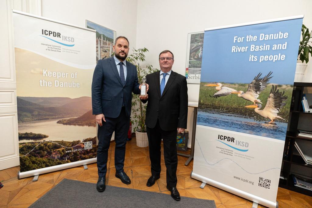 two men standing in front of two signs