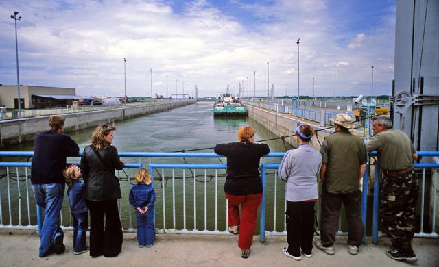 a group of people standing next to a fence