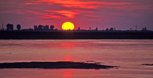 a sunset over a body of water