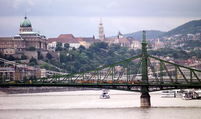 a train crossing a bridge over a body of water