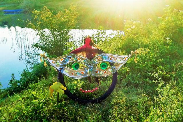 a colorful kite sitting on top of a grass covered field