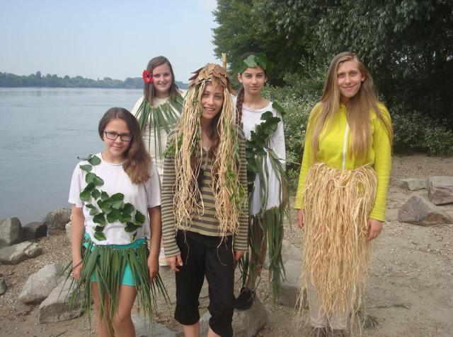 a group of people standing next to a body of water