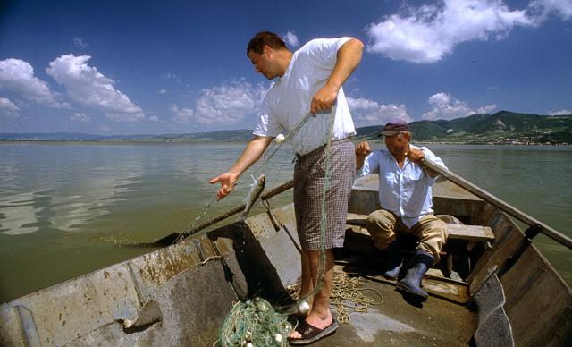 a fisherman standing on a boat