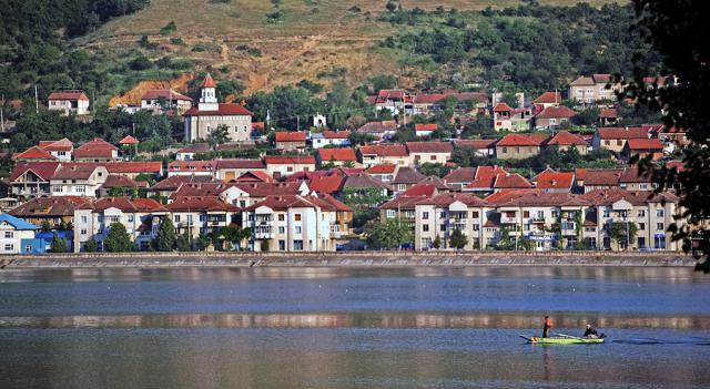 a body of water with a city in the background