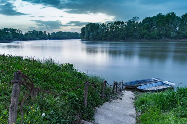 View of the Sava River with a small boat at the riverbank