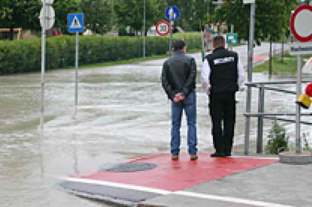 people walking down a flooded street